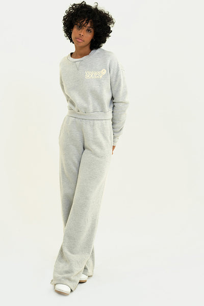 Model in Heather Grey Chloe Pants with a matching sweater, showcasing a modern straight leg style.