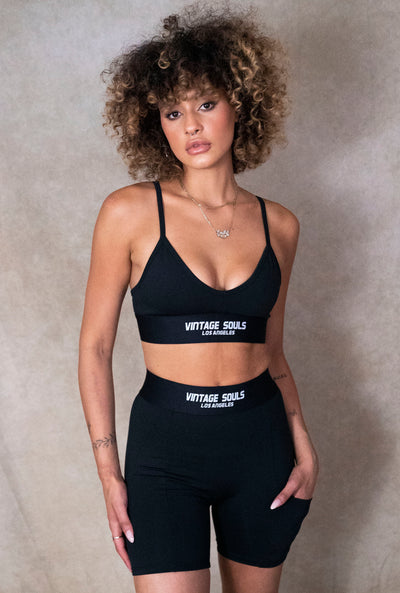 Model wearing Black Active Biker Shorts & Sports Bra crafted in LA from quality performance fabric.