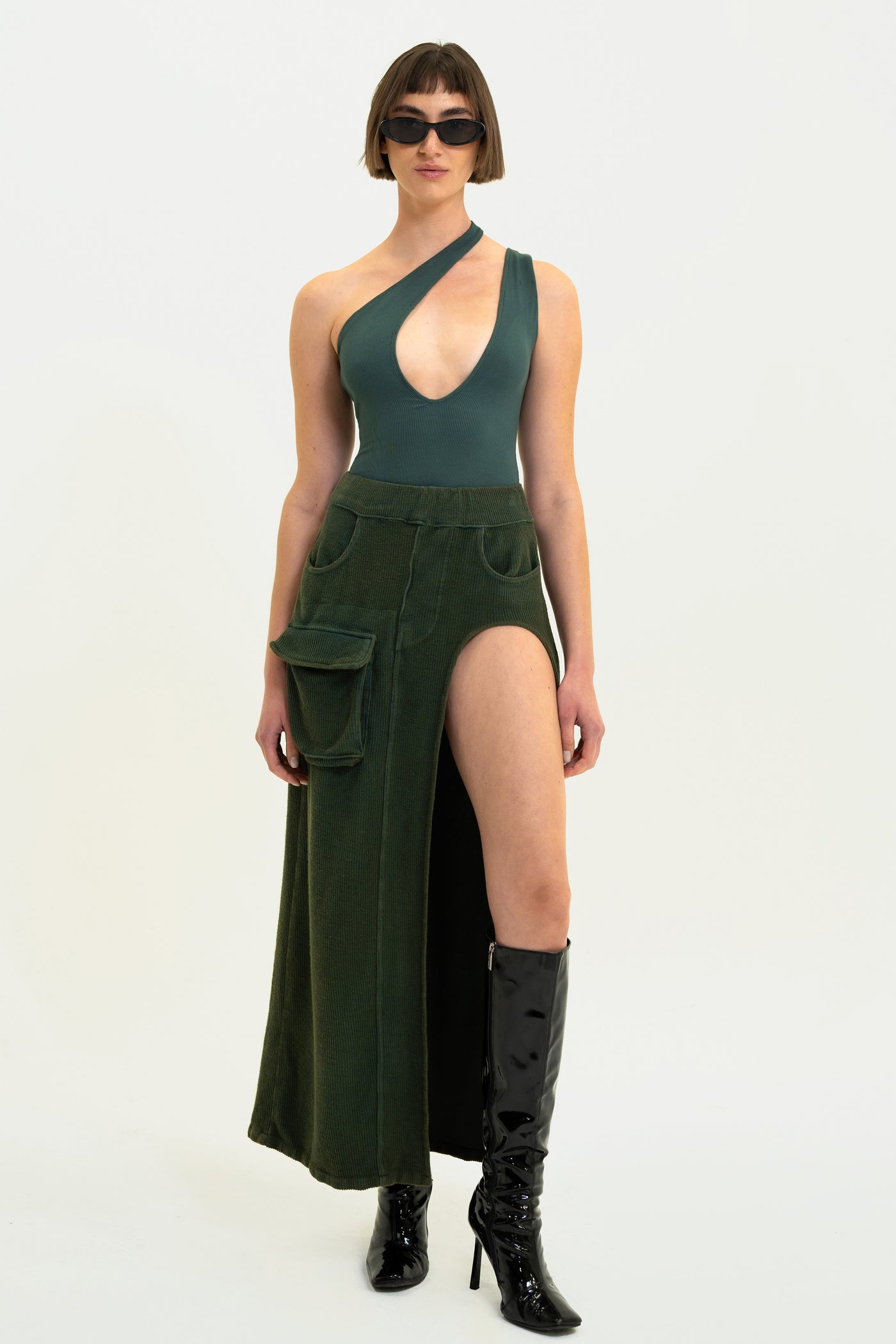 Olive Aspen Cargo Skirt with stylish cargo pocket, high leg slit, made from luxurious corded terry.