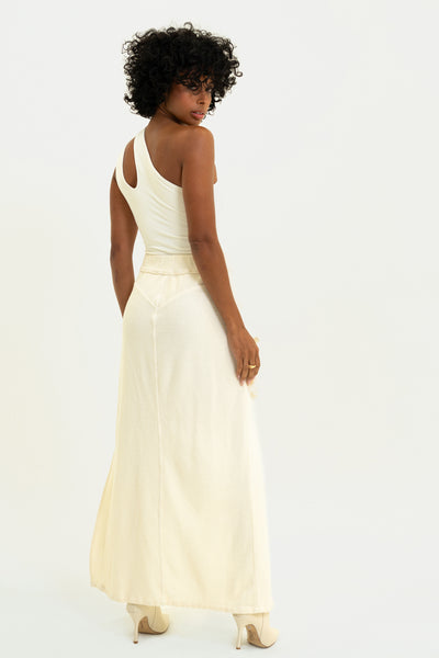 Model showing the back of the White Aspen Cargo Skirt with unique cargo pocket, high leg slit, in comfortable corded terry.