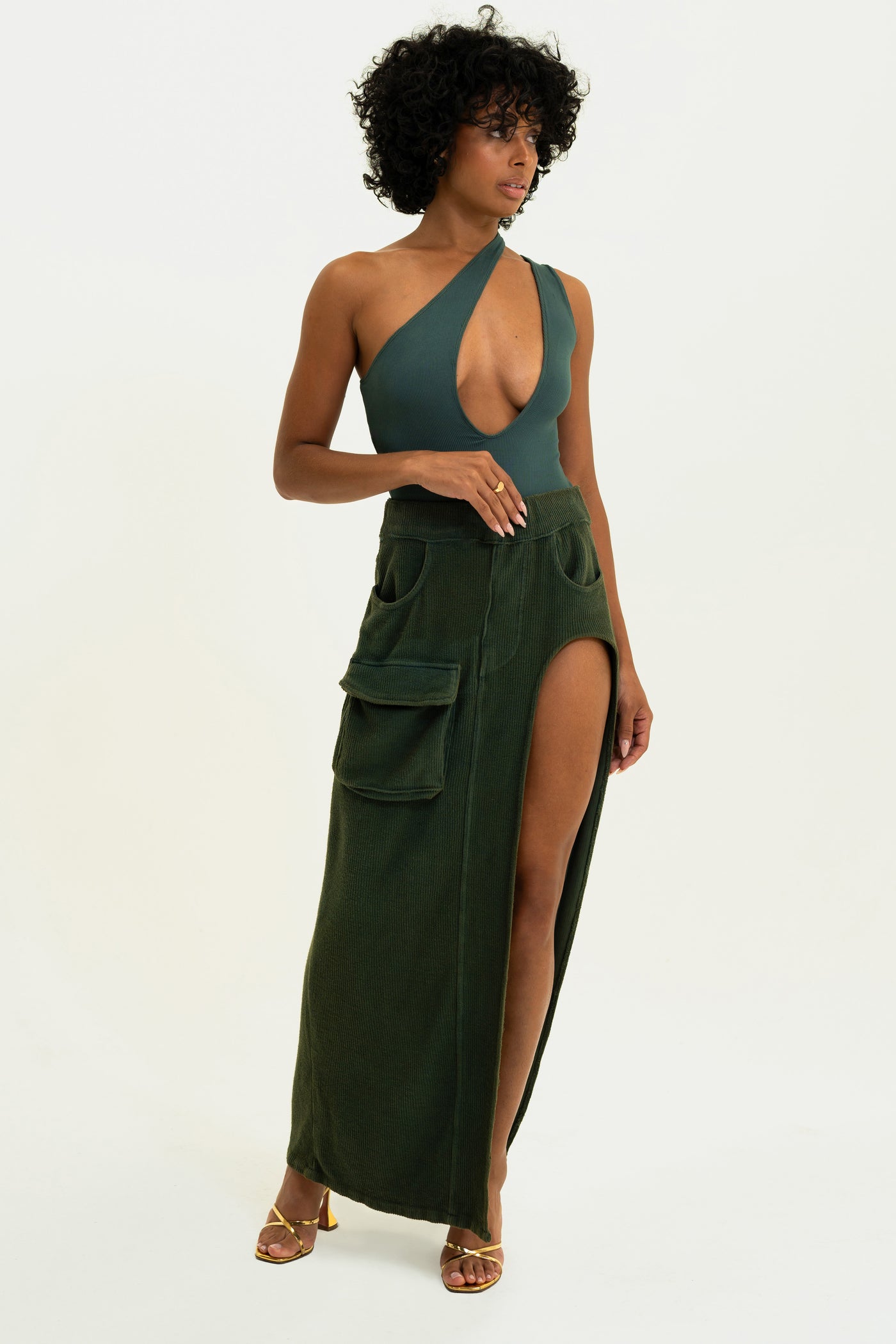 Model showcasing our Olive Asymmetrical Bodysuit. Super soft and made in the USA.
