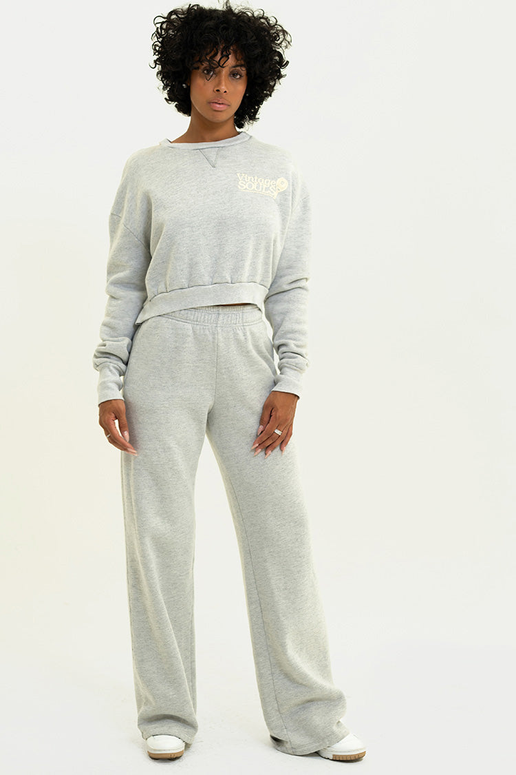 Confident model looking directly at the camera, wearing Heather Grey Chloe Pants, emphasizing their stylish fit and comfort.